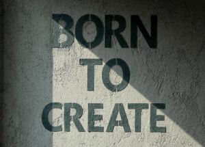 Born To Create in black writing on a gray concrete wall